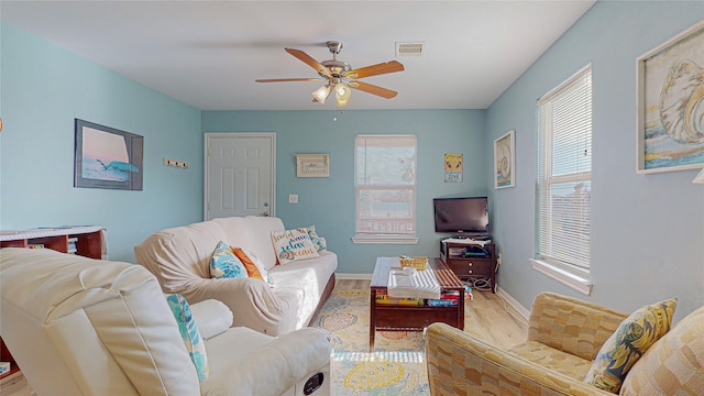 living room featuring light hardwood / wood-style floors and ceiling fan