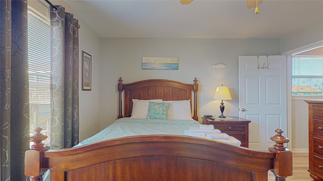 bedroom with ceiling fan and light hardwood / wood-style flooring