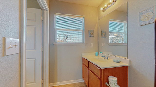 bathroom with plenty of natural light and vanity