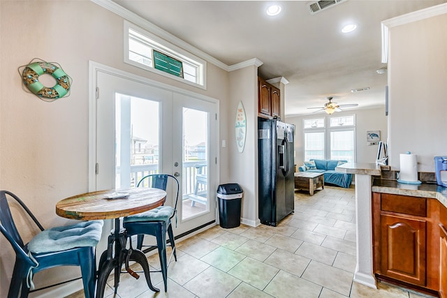 kitchen with french doors, black refrigerator with ice dispenser, ceiling fan, crown molding, and light tile patterned flooring