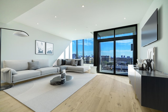 living room featuring light wood-type flooring and expansive windows