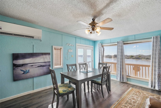 dining space featuring french doors, ceiling fan, a wall mounted air conditioner, dark hardwood / wood-style flooring, and a textured ceiling