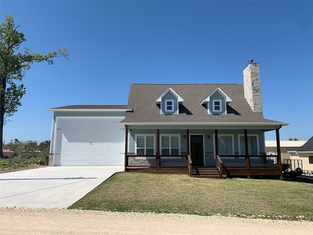 view of front of home featuring a front lawn, a porch, and a garage