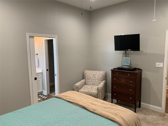 carpeted bedroom with ensuite bath