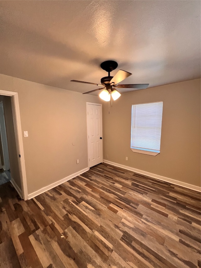 unfurnished room featuring a textured ceiling, ceiling fan, and dark hardwood / wood-style flooring