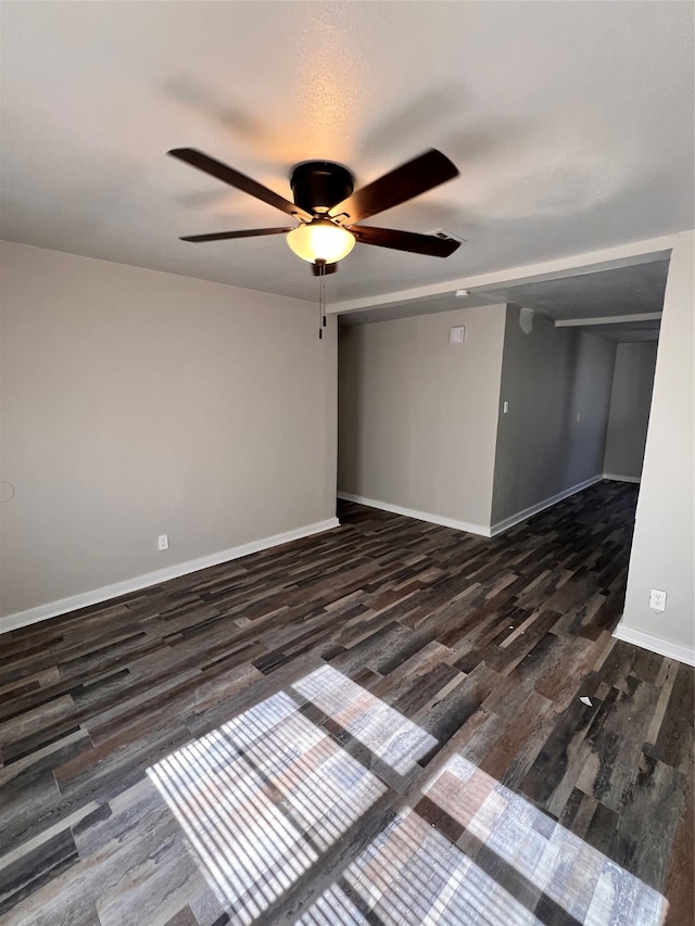 unfurnished room featuring ceiling fan and dark hardwood / wood-style floors