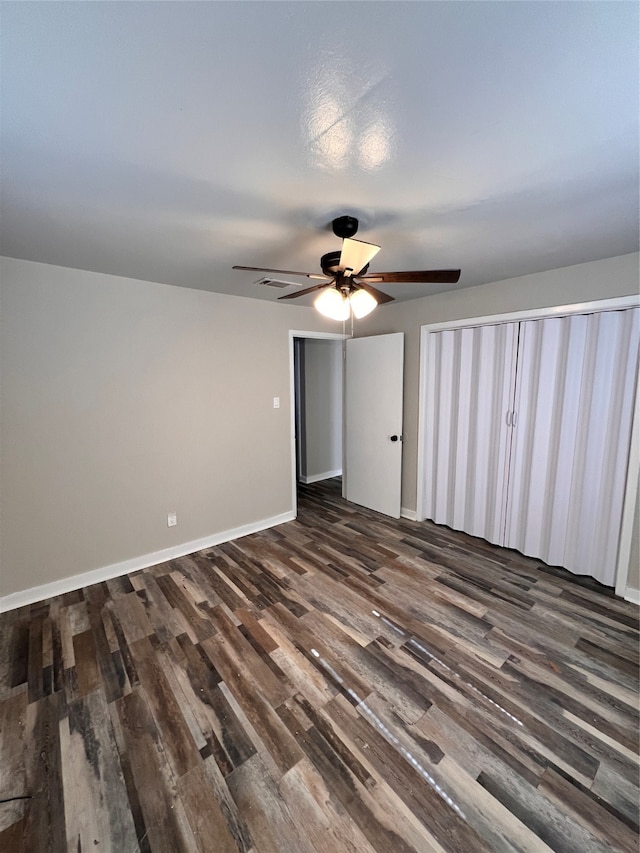 unfurnished room with ceiling fan and dark hardwood / wood-style flooring