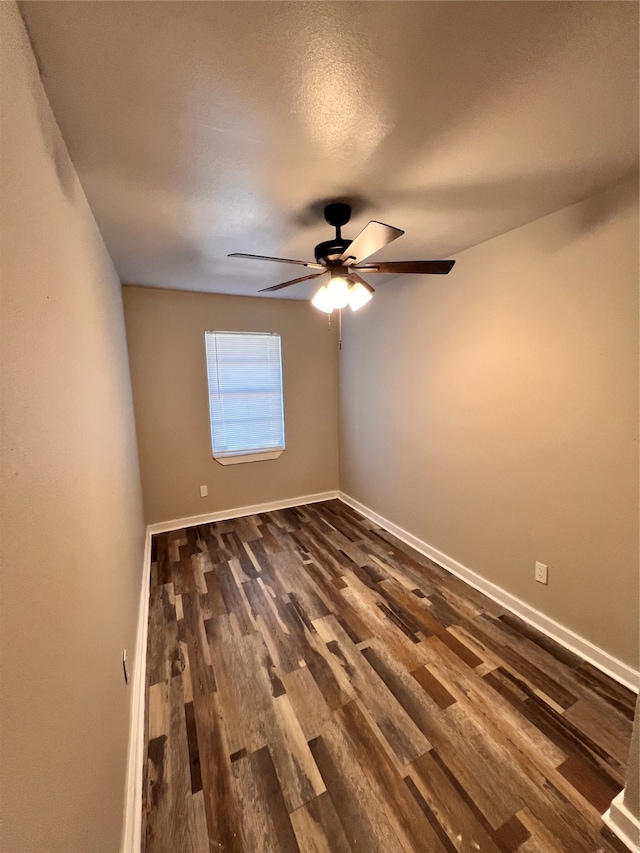 spare room with ceiling fan and dark hardwood / wood-style floors