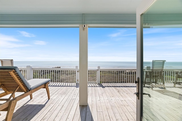 wooden terrace with a water view and a beach view