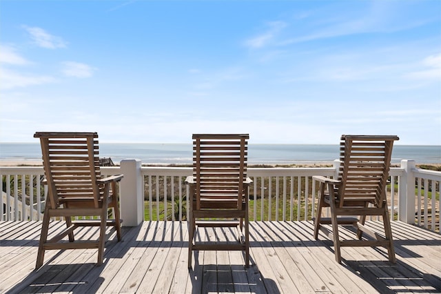 deck featuring a water view and a beach view