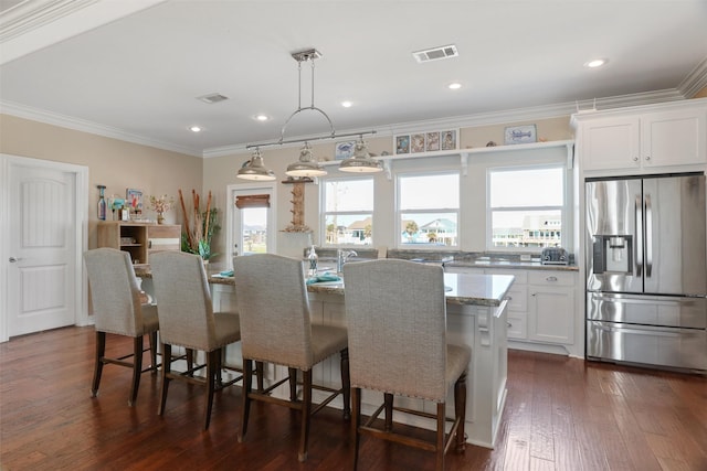 dining room featuring dark wood-style floors, recessed lighting, visible vents, and crown molding