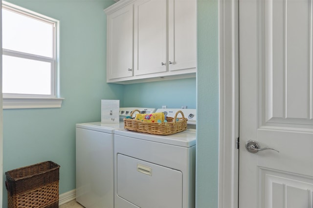 washroom with cabinet space and separate washer and dryer