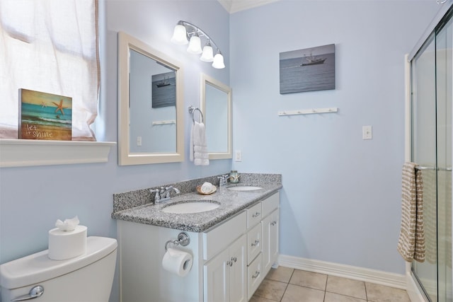 bathroom featuring toilet, baseboards, a sink, and tile patterned floors