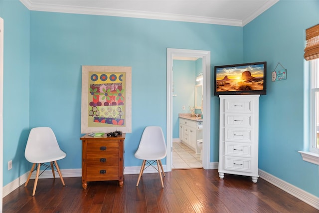 sitting room with crown molding, baseboards, and dark wood-type flooring