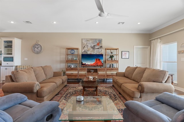 living area featuring recessed lighting, visible vents, and crown molding