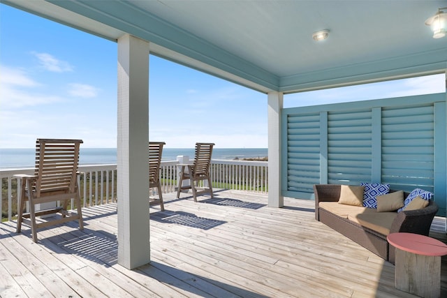 deck featuring a water view and an outdoor living space