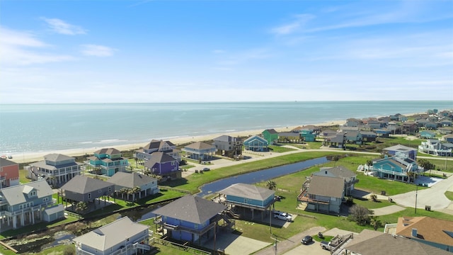 drone / aerial view with a residential view, a water view, and a beach view