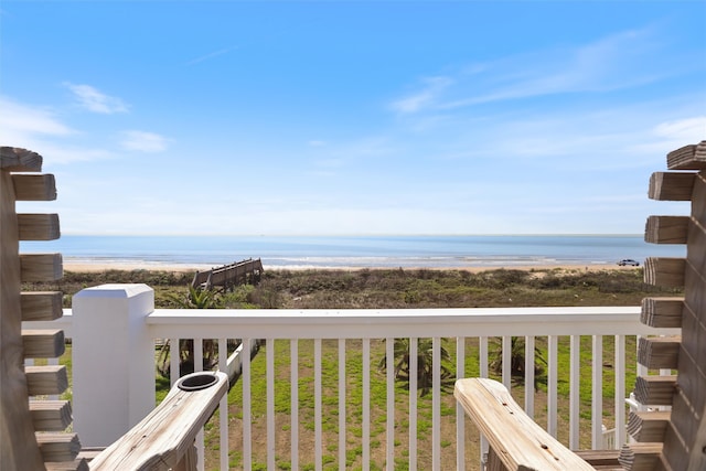 balcony with a water view and a view of the beach