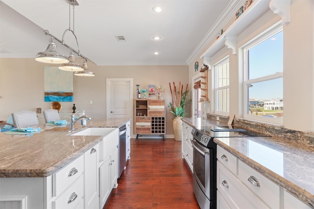 kitchen featuring appliances with stainless steel finishes, light stone counters, crown molding, white cabinetry, and pendant lighting