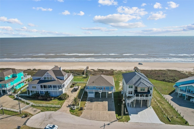 bird's eye view with a water view and a beach view