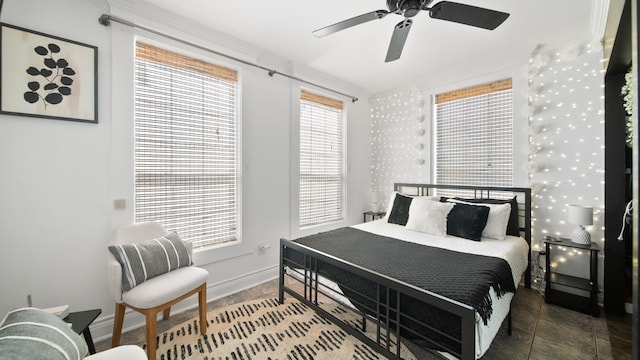 bedroom featuring a ceiling fan and baseboards