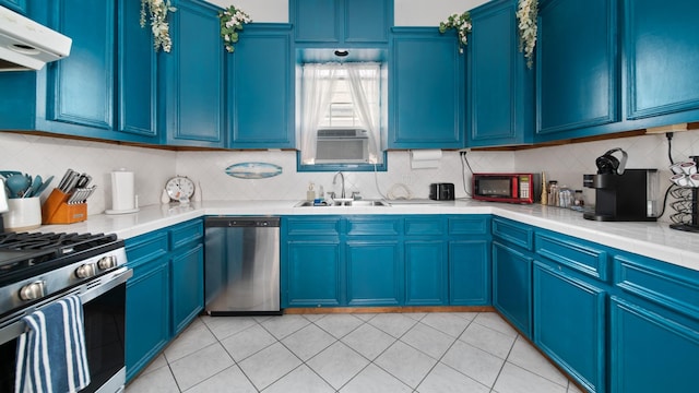 kitchen featuring a sink, blue cabinets, extractor fan, and appliances with stainless steel finishes