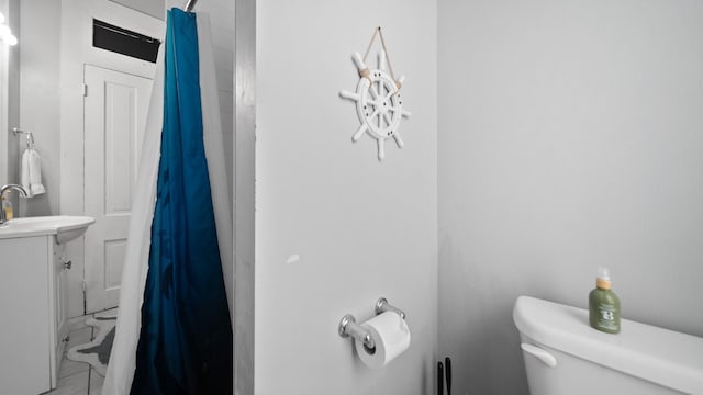 full bathroom with curtained shower, toilet, and vanity