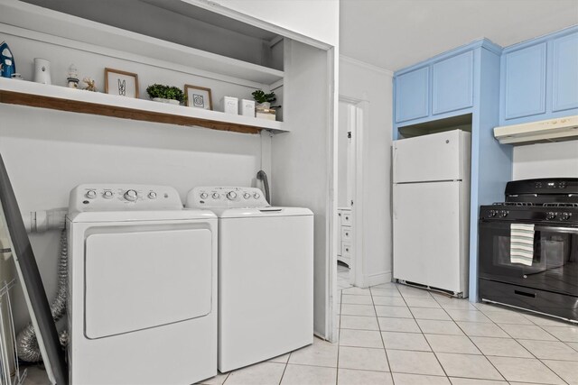 laundry area with light tile patterned flooring, laundry area, and washer and clothes dryer