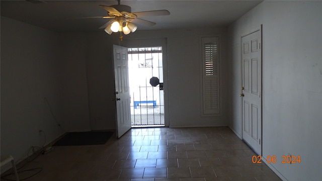 tiled entryway with ceiling fan