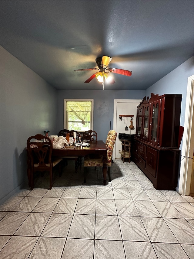 dining room with light tile floors and ceiling fan