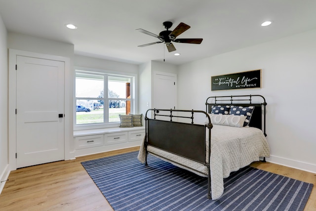 bedroom with ceiling fan and light hardwood / wood-style flooring