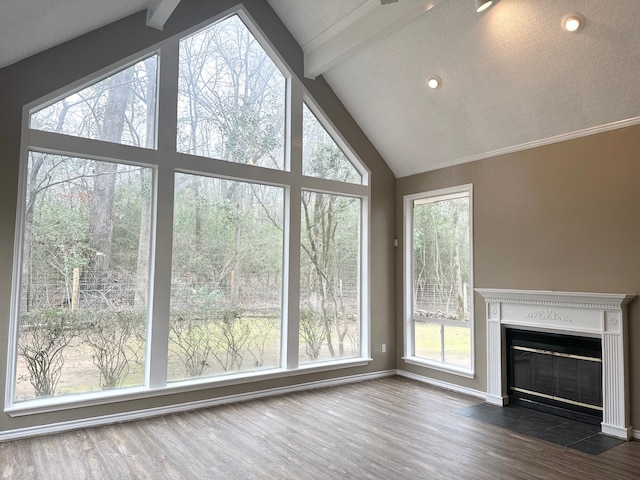 unfurnished living room featuring beamed ceiling, dark hardwood / wood-style floors, and high vaulted ceiling