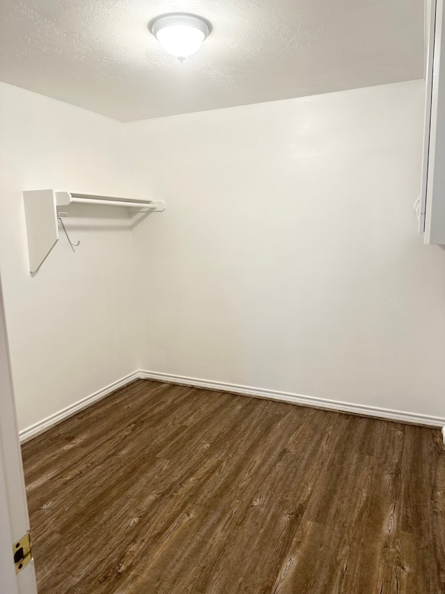 spacious closet featuring dark hardwood / wood-style flooring