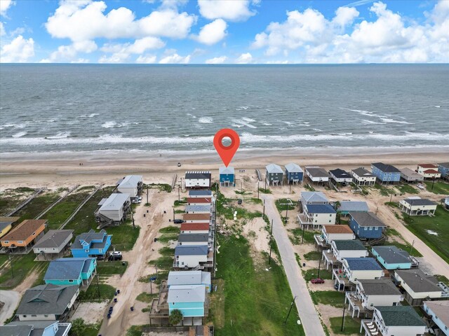 drone / aerial view featuring a beach view and a water view