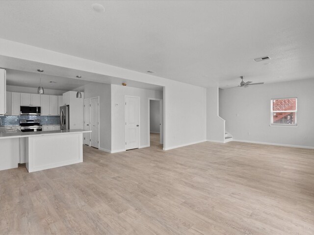 unfurnished living room featuring light hardwood / wood-style flooring and ceiling fan