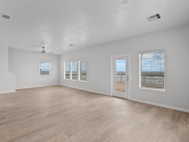 spare room with ceiling fan and light hardwood / wood-style floors