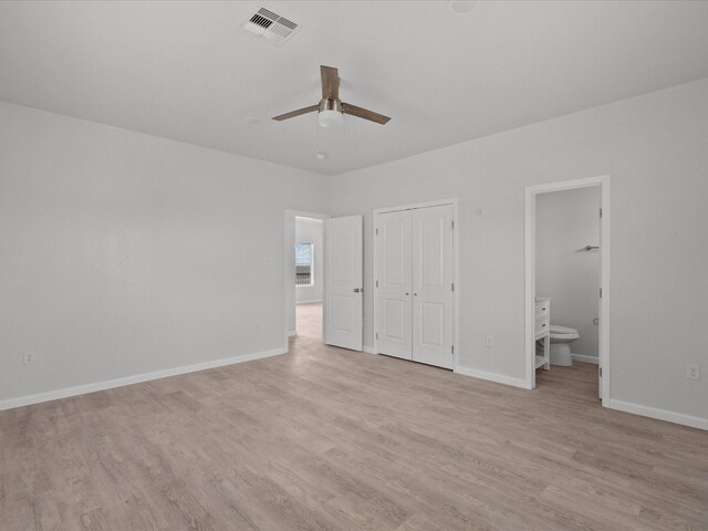 unfurnished bedroom with ceiling fan, connected bathroom, and light hardwood / wood-style flooring