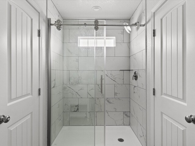 bathroom featuring a shower with shower door