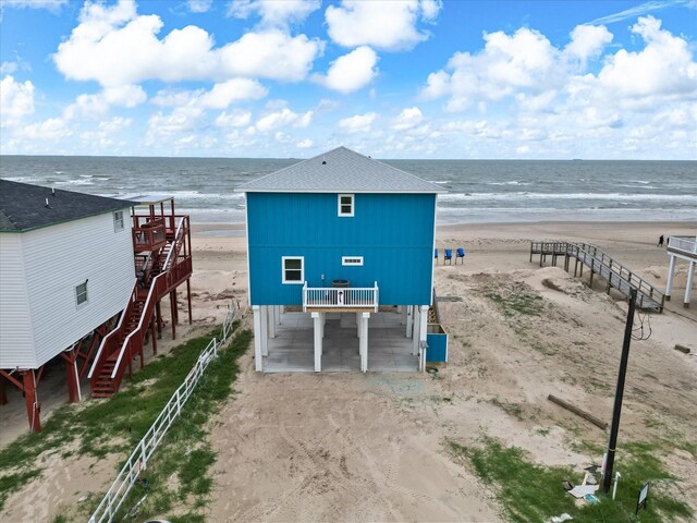 drone / aerial view with a beach view and a water view