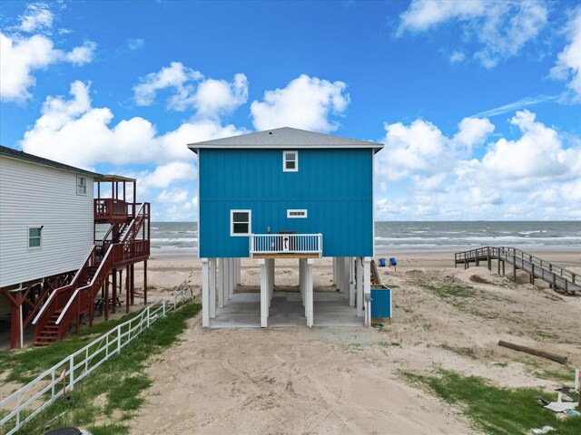 exterior space featuring a beach view and a water view