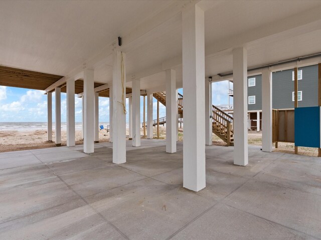 view of patio featuring a beach view and a water view