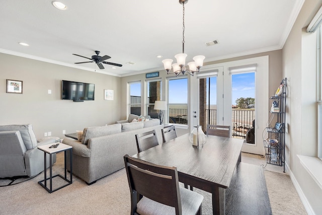 dining area featuring ceiling fan with notable chandelier and ornamental molding