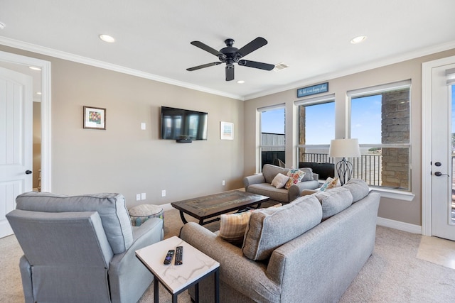 living room featuring crown molding, light colored carpet, and ceiling fan