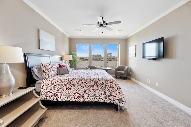 carpeted bedroom featuring crown molding and ceiling fan