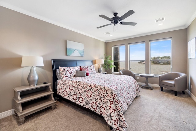 carpeted bedroom featuring a water view, ceiling fan, and crown molding