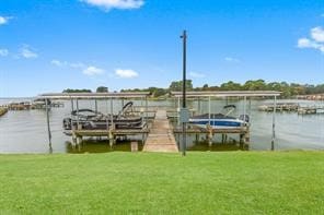 dock area with a water view and a lawn