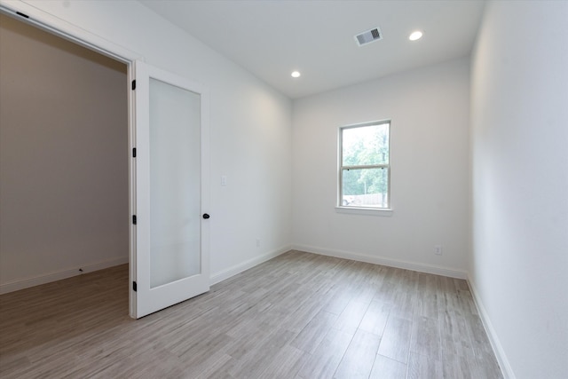 unfurnished room with light wood-type flooring