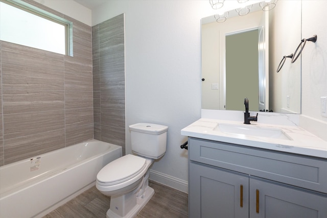 full bathroom featuring toilet, vanity, and tiled shower / bath