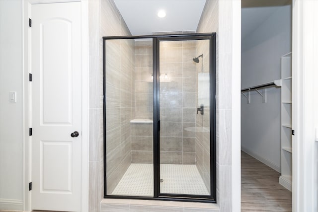 bathroom featuring an enclosed shower and hardwood / wood-style floors