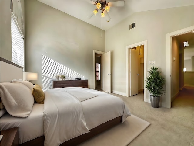 carpeted bedroom with high vaulted ceiling and ceiling fan